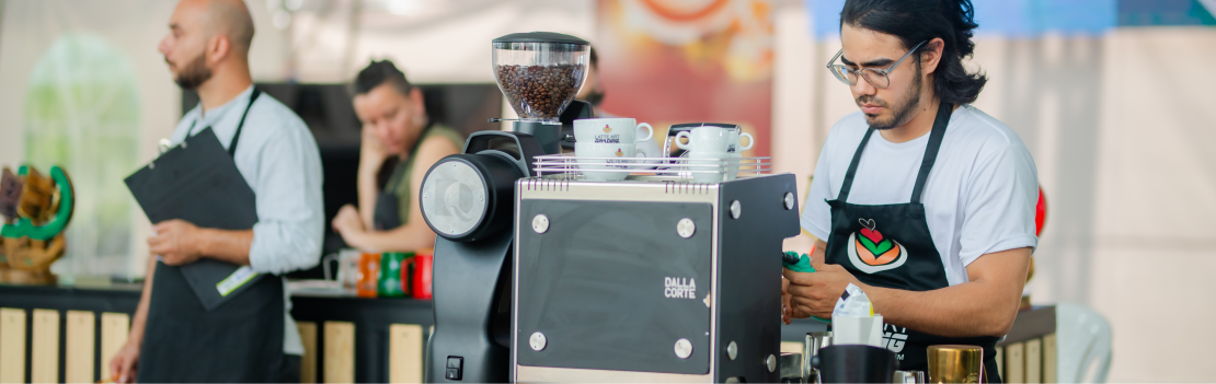 Barista prepara un espresso mientras los jueces observan con sus tablas